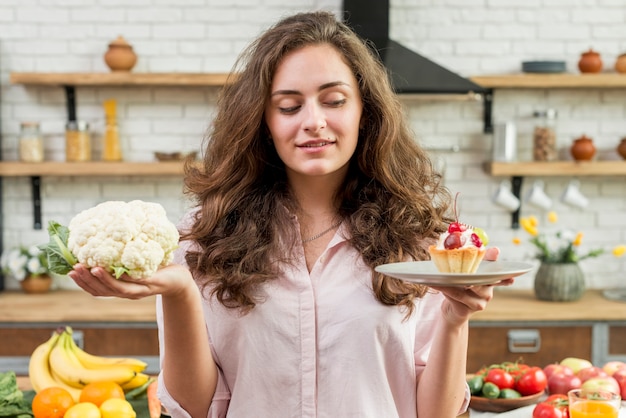 Brunette woman with cabbage and muffin