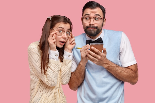 Brunette woman with pigtails and man wearing bowtie and vest