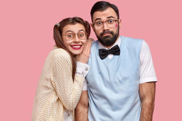 Brunette woman with pigtails and man wearing bowtie and vest