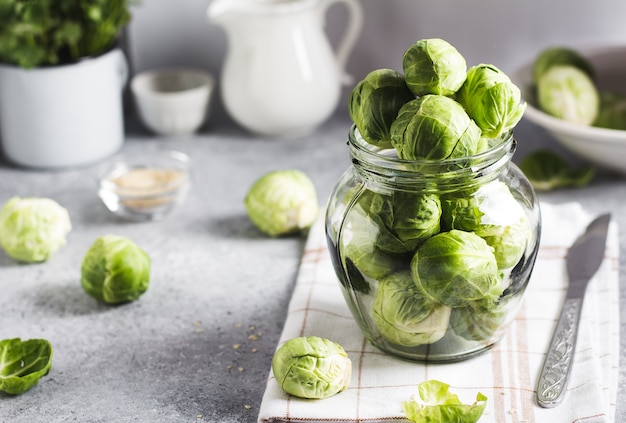 Brussels sprouts cabbage fresh organic in jar on table in kitchen