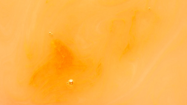 Free Photo bubble over an orange liquid paint background