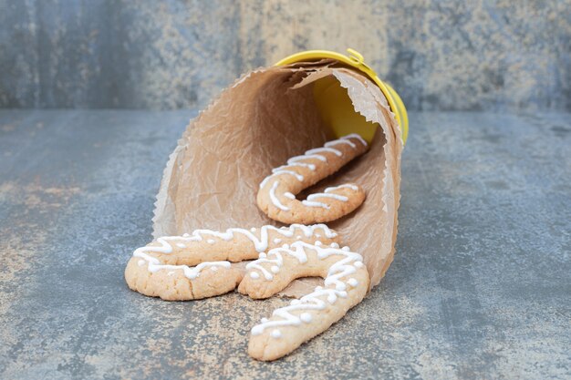 Bucket of gingerbread cookies on marble table. High quality photo