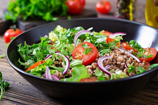 Buckwheat salad with cherry tomatoes, red onion and fresh herbs. Vegan food. Diet menu.