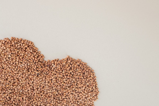 Buckwheat seeds isolated on concrete.