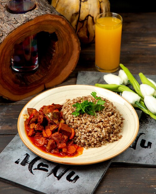 Buckwheat with meat and vegetables in tomato sauce