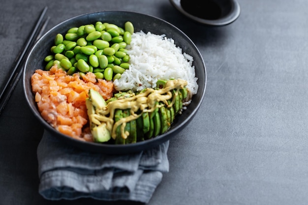 Buddha or poke bowl served on dark