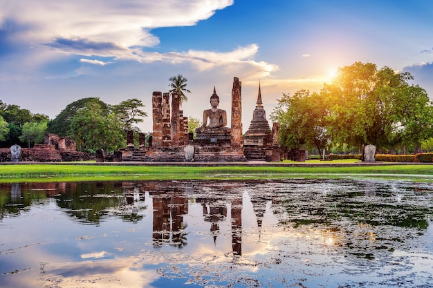 Buddha statue and Wat Mahathat Temple in the precinct of Sukhothai Historical Park