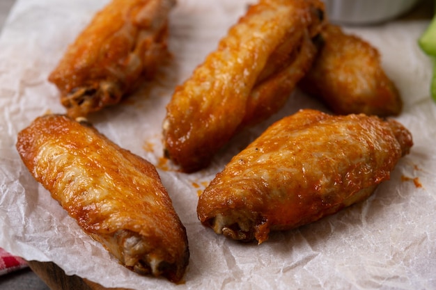 Free Photo buffalo spicy chicken wings with cayenne pepper sauce on wooden table