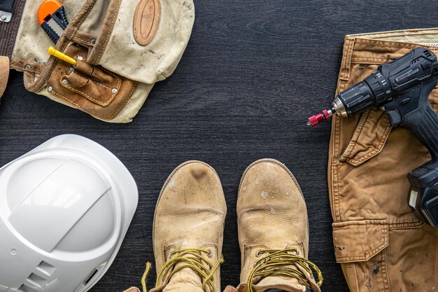 Builder clothes worker uniform on wooden background flat lay