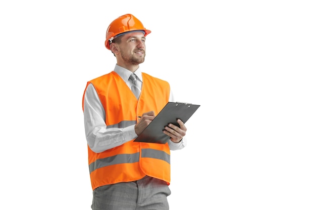 Free photo the builder in a construction vest and orange helmet standing on white studio