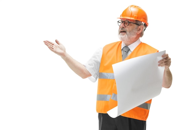 Free photo the builder in a construction vest and orange helmet standing on white.