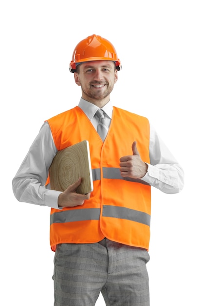 Free photo the builder in a construction vest and an orange helmet with laptop. safety specialist, engineer, industry, architecture, manager, occupation, businessman, job concept