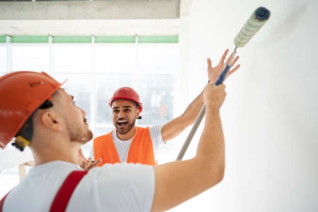 Free Photo building and construction workers on the site