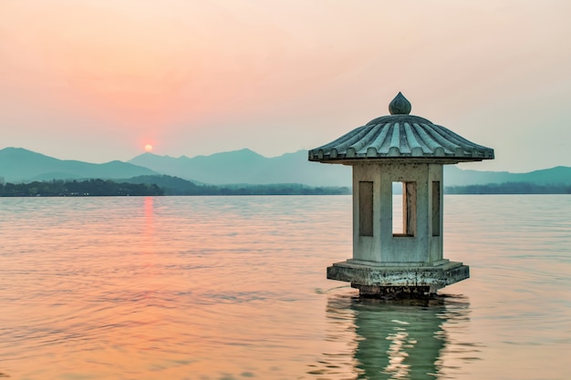 Building surrounded by water at sunset