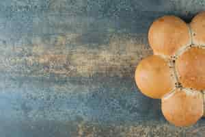 Free photo bun of fresh white bread on marble background