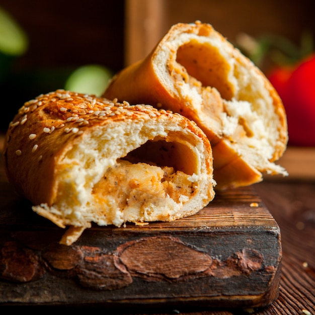 bun with jam in wooden plank