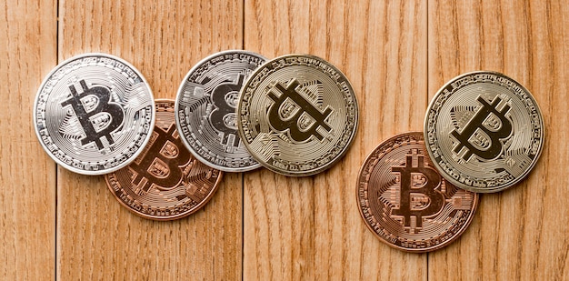 Bunch of bitcoins on wooden table