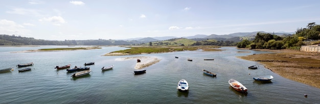 Free photo bunch of boats in water with a clear sky