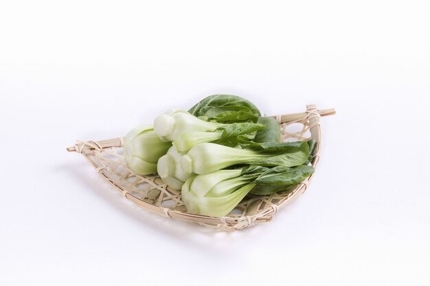 Bunch of bok choy on a straw plate