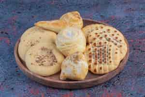 Free photo bunch of cookies on a small tray on abstract table.