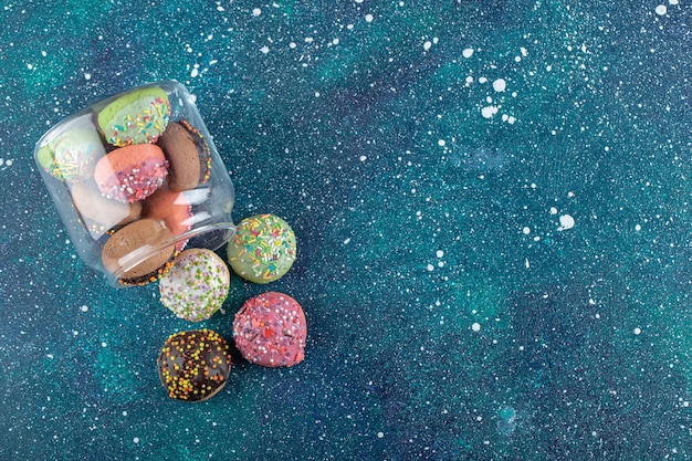 Free photo bunch of cookies with candies out of glass jar.