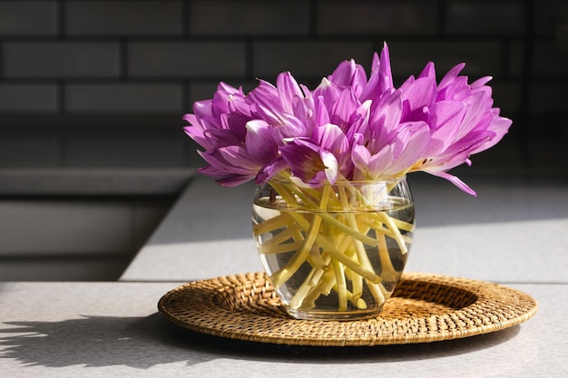 Free photo bunch of crocus flowers in a glass vase in the kitchen