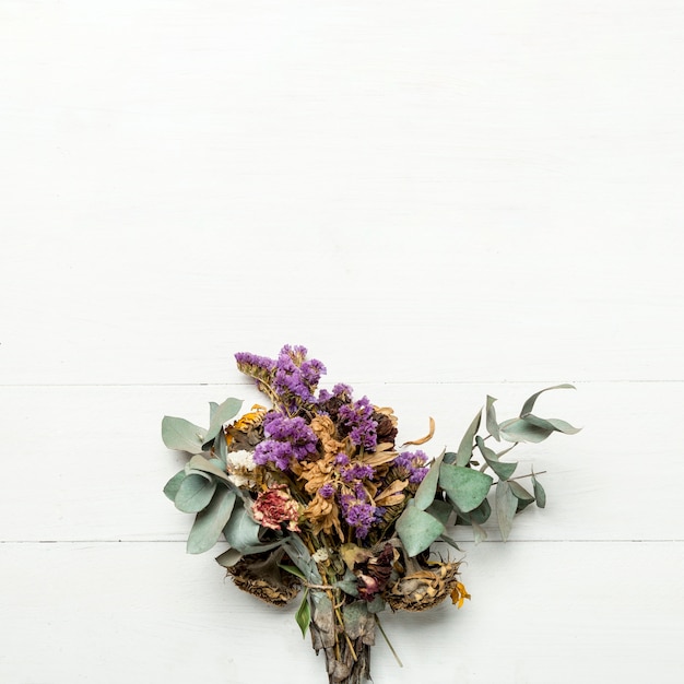 Free photo bunch of dried herbs and flowers on white surface