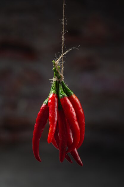 Bunch of dried red hot chili pepper on black.