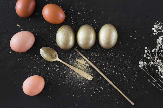 Bunch of eggs near spoon and brush