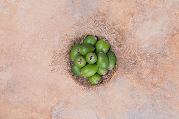 Free photo bunch of feijoas on orange table.