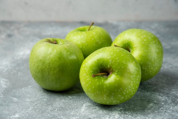 Bunch of fresh apples on marble.