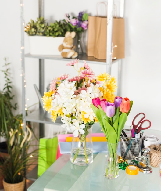 Bunch of fresh flowers on glass desk