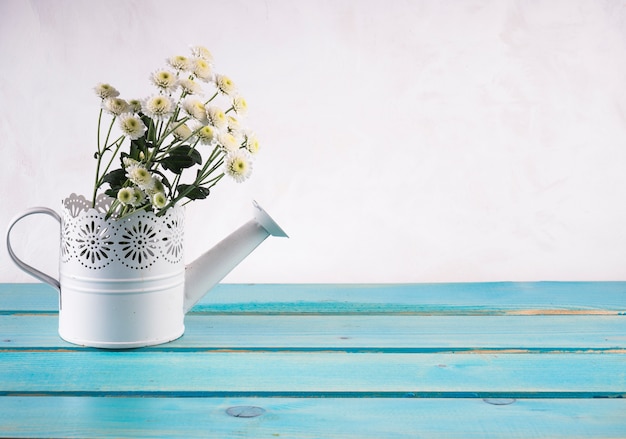 Free Photo bunch of fresh flowers in ornamental watering can