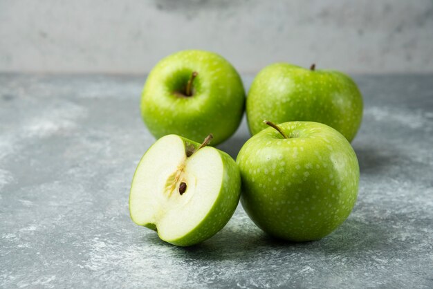 Bunch of green apples on marble.