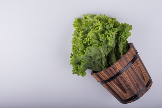 A bunch of lettuce in a wooden bucket