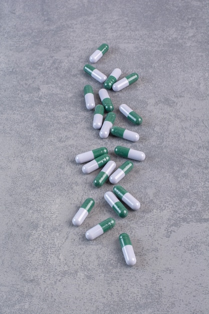 Free photo bunch of medical capsules on marble table.