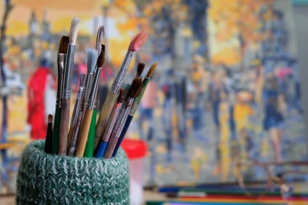 Bunch of painting brushes on a beautiful colorful background of a painting