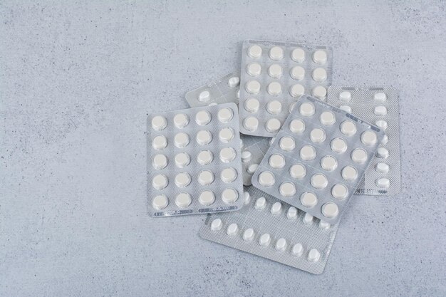 Bunch of pill packs on marble background. High quality photo