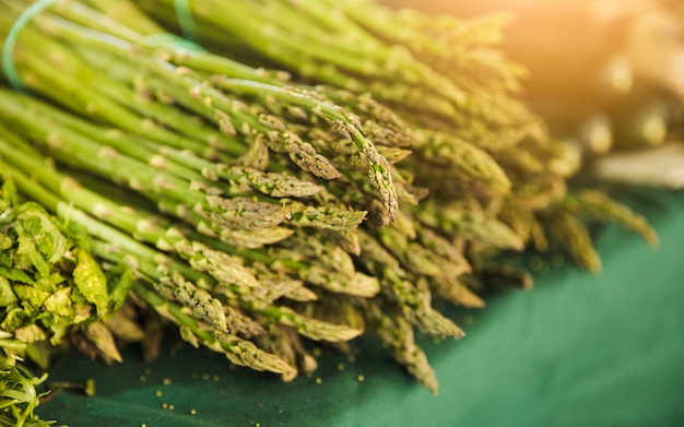 Bunch of raw garden asparagus on table for sale