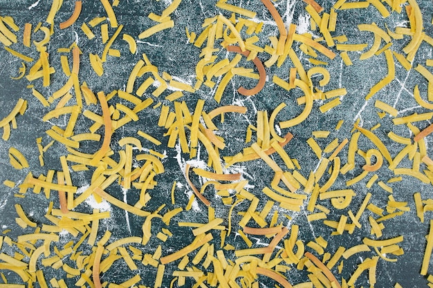 Bunch of raw pasta on blue background. High quality photo