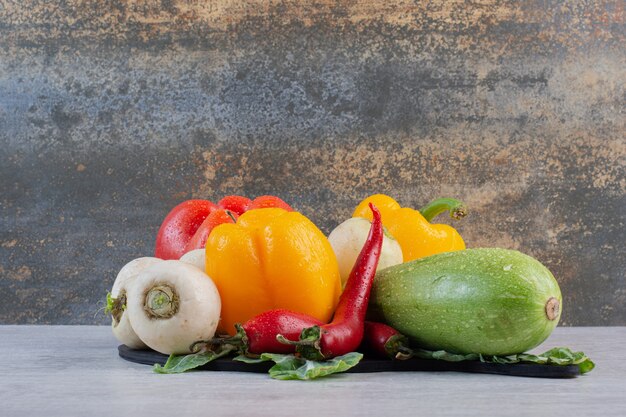 Bunch of raw vegetables on stone table. High quality photo