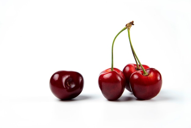 Free photo a bunch of red cherries on white background