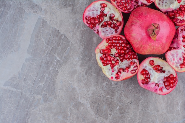 Bunch of red pomegranates on stone background. 