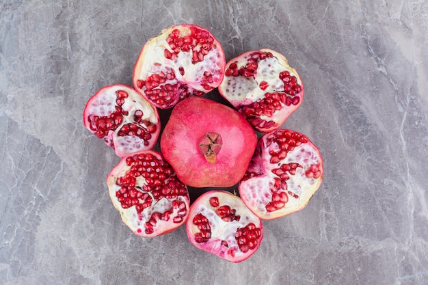 Bunch of red pomegranates on stone background. 