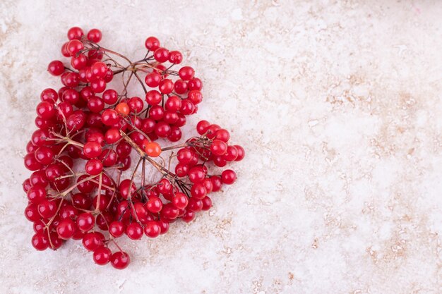 Bunch of redcurrants on marble background.