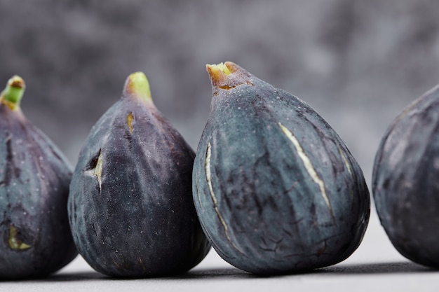 Bunch of ripe figs on marble.