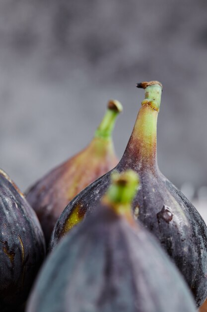 Free photo bunch of ripe figs on marble.