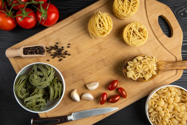 A bunch of tomatoes with italian pasta around