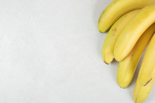 Bunch of yellow bananas on gray surface