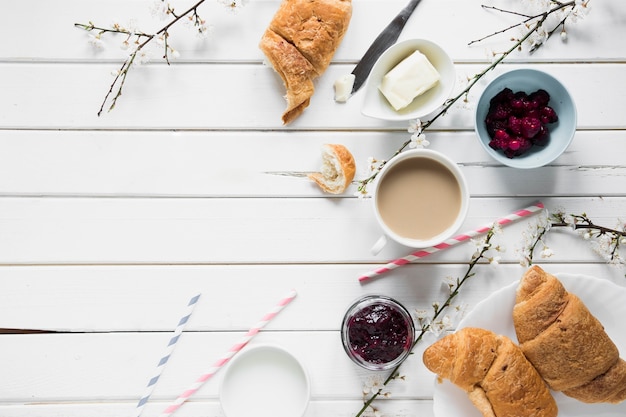 Buns and jam near coffee